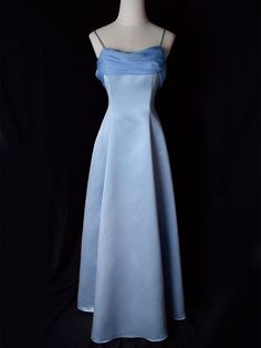 Step into timeless elegance with this Vintage Blue Satin Gown. Crafted from luxurious satin, this dress features delicate spaghetti straps that provide a graceful and feminine silhouette. The highlight of this gown is its unique winged back design, adding a touch of whimsy and sophistication. Perfect for formal occasions, evening events, or any special celebration, this elegant dress ensures you'll make a stunning entrance. The vintage blue hue adds a classic touch, making it a versatile additio Hot Prom Dress, Clothing Board, Mermaid Prom Dresses Lace, Purple Prom Dress, Vintage Prom, Prom Ideas, Sequin Prom Dresses, Prom Dresses Vintage, Formal Party Dress