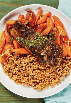 a white plate topped with meat, carrots and lentils