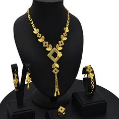 Indulge in luxury with this exquisite Dubai Gold Necklace Set, perfect for wedding parties. With its opulent design and superior craftsmanship, this set features a necklace, bracelet, earrings, and ring. Make a lasting impression and elevate your style with this luxurious jewelry set.' Metal Jewelry Sets With Clavicle Chain For Weddings, Wedding Jewelry Set With Metal Necklace, Wedding Jewelry Set With Clavicle Chain, Gold Plated Clavicle Chain Jewelry Sets For Parties, Formal Gold Jewelry Sets With Clavicle Chain, Elegant Alloy Jewelry Sets For Gifts, Elegant Gold Plated Jewelry For Party, Elegant Alloy Bridal Necklace As Gift, Elegant Alloy Bridal Necklace For Gift