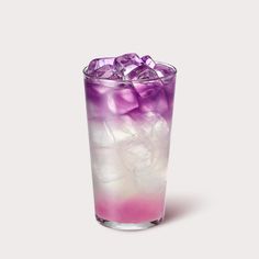 a tall glass filled with ice and purple liquid