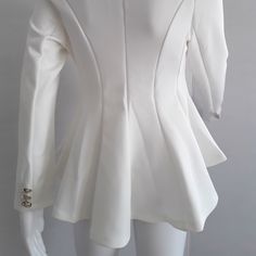 a mannequin wearing a white jacket with buttons on the front and back sides