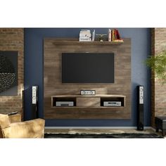 a living room with a television on the wall and speakers in front of it's entertainment center