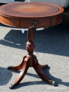 a small wooden table with two drawers on it