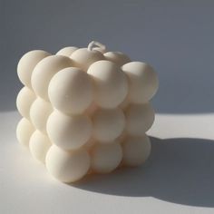 a bunch of white balls sitting on top of each other in front of a white background