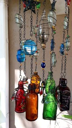 several different colored glass bottles hanging from chains