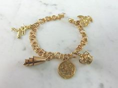 "FOR SALE IS A WOMENS VINTAGE ESTATE 14k GOLD CHARM BRACELET. THE BRACELET WEIGHS 25.4g, AND MEASURES 7\" LONG. THREE OF THE CHARMS ARE MARKED 14K. THE CROWN IS MARKED \"9K\", AND THE BELL CHARM IS 10K BUT NOT MARKED. ANY QUESTIONS PLEASE DON'T HESITATE TO ASK. THIS MAKES A GREAT GIFT FOR THAT SOMEONE SPECIAL. BE SURE TO CHECK OUT SOME OF MY OTHER GREAT ITEMS UP FOR SALE. THANK YOU." Antique Gold Bracelet Stamped 14k, Antique 14k Stamped Gold Bracelet, Vintage Gold-tone Gold-plated Bracelet, Vintage Engraved Yellow Gold Charm Bracelet, Antique Yellow Gold Bracelets With Vintage Charm, Heirloom Gold Bracelet Stamped 14k, Vintage Gold Tarnish-resistant Bracelet, Antique 14k Gold Bracelets, Vintage Charm Yellow Gold Bracelet