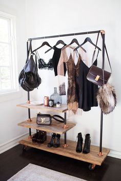 a rack with shoes, purses and handbags hanging from it's sides