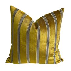 a yellow and grey striped pillow on a white background