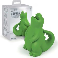 two green alligator shaped toothbrushes in front of a box