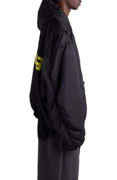 Balenciaga's streetwear-ready aesthetic is on display with this oversized, hooded bomber jacket branded with taped-up logo lettering for a DIY vibe. 29" length (size 2) Two-way front-zip closure Fixed hood Ribbed cuffs and hem Front welt pockets; sleeve utility pocket Lined, with silk/polylactide fill 100% polyamide Hand wash, line dry Made in Italy Designer Clothing Techwear Streetwear Outerwear With Padded Collar, Techwear Outerwear With Padded Collar For Streetwear, Urban Windbreaker With Padded Collar For Streetwear, Streetwear Windbreaker With Padded Collar, Streetwear Nylon Outerwear With Double-lined Hood, Oversized Hooded Windbreaker For Streetwear, Black Windbreaker With Padded Collar For Streetwear, Oversized Windbreaker With Adjustable Hood For Streetwear, Nylon Outerwear With Double-lined Hood For Streetwear