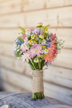 a bouquet of colorful flowers tied to a burlock