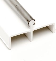 an aluminum pipe sticking out of the side of a white wall with one end missing