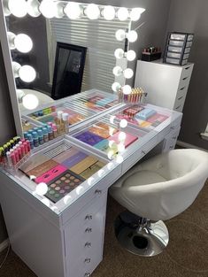 a vanity with makeup and lights on it