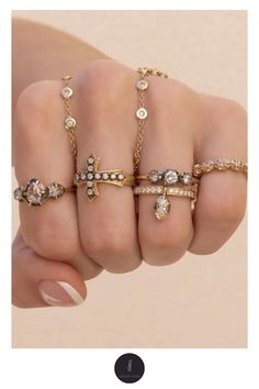 a woman's hand with five different rings on it and the text, how to wear gold jewelry