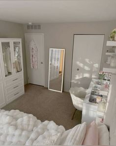 a bedroom with a bed, dresser and mirror on the wall next to closets