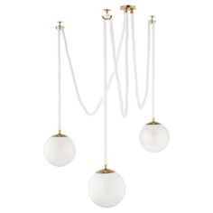 three white and gold hanging lights with ropes attached to each light fixture, one on top of the other