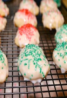 there are many decorated cookies on the cooling rack in front of each other and sprinkles all over them