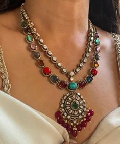 Step into the grandeur of the Victorian era with our captivating Navratan  necklace set, meticulously crafted to evoke the opulence of a bygone age. Showcasing mesmerizing Semi Precious stones, reminiscent of lush emerald gardens, this masterpiece is elegantly encircled by sparkling Polki stones, paying tribute to the era's unparalleled artistry. This exquisite set is a testament to refined indulgence, perfect for adding a touch of vintage sophistication to any ensemble. Set Includes  1) Pair of Earrings  1) Necklace  Earrings have pushbacks  Necklace has Adjustable Dori .  Customized orders takes 3 to 4 weeks, depending on piece requirements.  The Ombre Designs Jewelry pieces can be customized in accordance with your requirement.  Please Email or Whats app on : +91 8448833193 / sonalikame Multicolor Pendant Temple Necklace For Wedding, Multicolor Necklace With Intricate Design For Ceremonial Occasions, Ceremonial Multicolor Necklace With Intricate Design, Ceremonial Kundan Necklace With Stone Work For Eid, Traditional Round Necklaces For Eid, Multicolor Temple Necklace With 17 Jewels For Wedding, Traditional Multicolor Necklace With Intricate Design, Festive Temple Necklace With 17 Jewels In Chandbali Shape, Traditional Necklace With Intricate Design For Eid