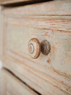 an old dresser has rusted knobs on it