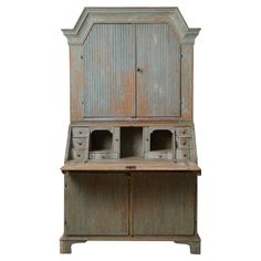 an old wooden desk with drawers and cupboards on the top, against a white background