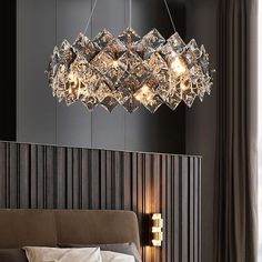 a bed room with a neatly made bed and a chandelier hanging from the ceiling