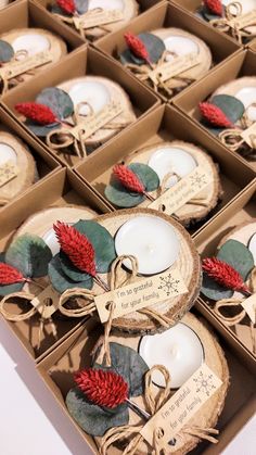 some candles are sitting in small boxes on the table