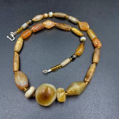 The beautiful mala necklace consist of Himalayan luk Mik or we called them magic eye bead as well in the center of the mala necklace with Banded Agate ,carnelian . Luk Mik means (Goat's eyes) in Tibetan Natural found from Himalaya Tibet dating more than 1000 yrs. The origin of this beads from Himalaya Tibet but also can found in India, Nepal and Pakistan too They were used as a special charm Jewelry and amulet at that time period very good condition They were used in prayers mala and used as amu Spiritual Tumbled Agate Jewelry, Spiritual Amber Beaded Necklaces With Natural Stones, Spiritual Amber Beaded Necklace With Natural Stones, Spiritual Hand-strung Amber Beaded Necklaces, Spiritual Amber Polished Beads Jewelry, Artisan Amber Jewelry For Meditation, Amber Natural Stone Necklace, Handmade Spiritual Amber Beads, Gems, And Cabochons, Spiritual Large Beads Necklace For Rituals