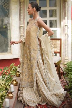 Cotton Silk Sharara With Dupatta For Reception, Bollywood Style Cream Dress With Sheer Dupatta, Gold Cotton Silk Palazzo Set For Wedding, Cotton Silk Kurta With Mirror Work For Reception, Festive Cotton Silk Palazzo Set With Intricate Embroidery, Designer Anarkali Embellished Kurta, Anarkali Embellished Designer Wear Kurta, Anarkali Embellished Kurta For Designer Occasions, Cream Bollywood Chanderi Dress