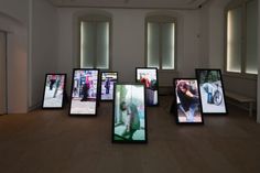 a room filled with lots of different types of televisions on top of wooden floors