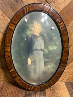 an image of a statue in a wooden frame on the wall with wood paneling