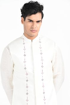 Ivory Phulkari inspired Nehru Jacket with pipe, cutdaana and thread work embroidery with same coloured kurta with embroidery detail on the chest and sleeve. this set in made in linen Satin, Paired with Ivory slim fit Pant Pajama. Color of
the actual garment may vary due to lighting conditions during the shoot.

Size Chart For Men





	
	
					Men's Size Chart
		

		
		
						
				Size Chart For Men
				Custom Size Measurement Guide
			
			
				
				
				Custom Size Measurement Guide
1. Take you Designer Nehru Jacket With Chikankari Embroidery, Designer Embroidered Bandhgala With Straight Kurta, Traditional Drape Nehru Jacket With Floral Embroidery, Designer Chanderi Sherwani With Resham Embroidery, Designer Chanderi Bandhgala With Embroidered Border, White Chanderi Bandhgala With Cutdana, Elegant White Chanderi Nehru Jacket, Chanderi Nehru Jacket With Floral Embroidery, Designer Nehru Jacket With Intricate Embroidery For Festive Occasions