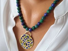 🌼 Embrace the beauty of life with our stunning Green Blue Life Flower Necklace! 💚💙 Crafted from high-quality brass and adorned with a vibrant array of colors, this necklace features a gorgeous gold-plated floral pendant in the shape of a life flower. 🌸✨ Whether you're adding a pop of color to your everyday attire or seeking a meaningful gift for a loved one, this necklace is sure to bring joy and positivity to any occasion! 🎁 Elevate your style and celebrate the beauty of life with this exq Gold Necklace With Natural Stones And Flower Pendant, Multicolor Brass Elegant Necklaces, Blue Bohemian Necklace With Flower Charm, Elegant Multicolor Brass Necklaces, Gold Flower Pendant Jewelry With Natural Stones, Multicolor Brass Beaded Necklaces As Gift, Gold Beaded Necklaces With Flower Pendant For Jewelry Making, Elegant Brass Necklaces With Flower Charm, Elegant Brass Necklace With Flower Charm