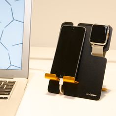 a cell phone holder attached to a laptop