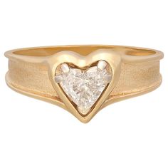 Love is in the air! With this 14k gold engagement ring, express your love with a heart-shaped diamond weighing approximately .58-ct., and graded G-H color and VS-SI. Set in a polished heart frame with a tapering satin band, the ring harks back to the 1950's era of love and optimism. The ring weighs 3.1 grams, and is currently size 8, with easy up/down adjustment. A ring of pure romance! Antique Sapphire Engagement Rings, Vintage Sapphire Engagement Rings, Heart Cut Diamond Ring, Big Diamond Rings, Heart Diamond Ring, Heart Shaped Diamond Ring, Heart Shaped Engagement Rings, Easy Up, Sapphire Engagement Rings