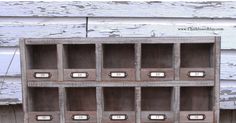 an old wooden shelf with many drawers