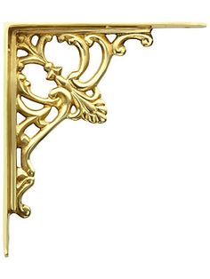 an ornate gold shelf bracket on a white background