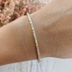 Our Toryn baguette round alternating diamond bracelet is available in lab grown and natural diamonds and can be customized with larger diamonds or different gemstones. Contact us for a quote on any customization to get started on a custom order: http://etsy.me/1231fkN Details: - Made in New York, USA. - Bracelet is 7 inches in length, and 2.3mm wide. Contact us for different dimensions. - Choose between lab grown (VS+F) or Natural diamonds (VS+G) - Approximate carat weight is 1 carat. - High pol Yellow Gold Diamond Bracelet With Baguette Diamonds, Yellow Gold Diamond Bracelet With Baguette Cut, Timeless Yellow Gold Diamond Bracelet With Baguette Diamonds, 14k Yellow Gold Diamond Bracelet With Baguette Cut, Yellow Gold Baguette Diamond Bracelet Gift, Usa Bracelet, Diamond Bangles Bracelet, Cvd Diamond, Types Of Diamonds