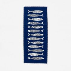 a blue and white wall hanging with fish on it