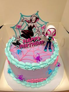 the birthday cake is decorated with spiderman and webs on it's sides