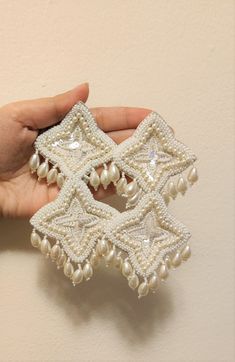 White Beaded Earrings Handmade Handmade White beaded embroidered Statement Earring White Earrings These earrings are purely handmade and hand-embroidered oversize earrings. These are beautiful and look pretty on anybody. It has a double-sized triangle pattern with embroidered beads work. This can be used for wedding and bridal wear or as casual. Earrings measure about approx. 5 inches long and 2.5 inches wide (first triangle) and 3 inches wide (second triangle) Product Weight: 1.38 oz Color: Whi White Boho Earrings, Affordable White Beaded Chandelier Earrings, White Bohemian Festive Earrings, Hand Embroidered Earrings, Festive Beaded Dangle Pearl Earrings, Handmade White Earrings For Festive Occasions, White Bridal Earrings With Dangling Beads For Party, Festive White Handmade Earrings, White Danglers For Party