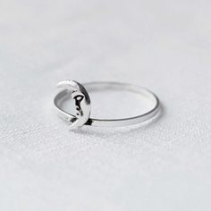 Real 925 Sterling Silver Crescent Moon Ring Ring Face Measures 8.50 x 6mm Ring Band Thickness measures 1mm Jewelry will come in a gift box * Please read shop policy before placing an order * *JEWELRY CARE* Sterling Silver will tarnish over time, but to help keep your jewelry looking beautiful - Clean with a soft dry cloth after wear and store inside an airtight bag or container. Remember to remove your jewelry when: * Applying lotion or sunscreen * Applying perfume * Taking a shower / bath * Wor Adjustable Rings With Moon Charm, Adjustable Moon-shaped Midi Promise Rings, Adjustable Moon Charm Promise Ring, Minimalist Adjustable Ring With Moon Charm, Adjustable Moon Charm Ring For Anniversary, Adjustable Moon Shaped Promise Ring, Minimalist Sterling Silver Moon Midi Rings, Minimalist Silver Moon Phase Ring, Adjustable Moon Shaped Symbolic Rings