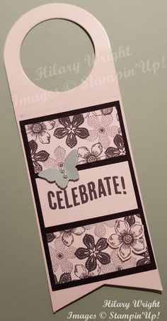 a white door hanger with a black and white tag on it that says celebrate