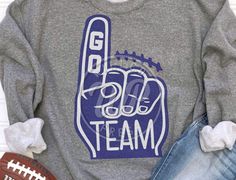 a sweatshirt with the word team written on it and a football in front of it