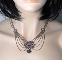 A wonderful fine 835 European silver necklace circa 1920 set with cultured pearls and Natural Amethyst Cabochons. This very feminine necklace is designed to drape beautifully down the decolletage. The pendant at the front including the drop measures approximately 1 9/16" and is 1 9/16" side to side (40mm x 39mm). It is set with four cultured pearls each approximately 3.5mm in diameter. The top amethyst cabochon measures 7.5mm by 5.5mm approximately and the one at the bottom measures approximatel Victorian Silver Necklace With Historical Design, Silver Necklaces With Historical Design For Wedding, Antique Silver Necklace With Historical Design, Victorian Jewelry With Historical Design For Evening, Antique Pearl Necklace For Formal Occasions, Victorian Evening Necklace With Hallmark, Victorian Hallmarked Necklace For Evening, Antique Wedding Necklaces With Jewels, Victorian Pearl Necklace For Formal Occasions