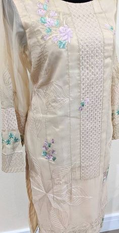 Beige color kurta with full embroidered front panel along with hint of green and purple bunches on sleeves and daman. Additional information - Fabric is banarsi Size Small Spring Cotton Silk Salwar Kameez With Dabka Work, Spring Chanderi Lawn Suit With Intricate Embroidery, Elegant Chanderi Embroidered Fabric, Elegant Unstitched Suit With Dabka For Spring, Elegant Unstitched Dabka Suit For Spring, Elegant Spring Dabka Unstitched Suit, Beige Long Sleeve Lawn Suit For Spring, Unstitched Embroidered Suit With Long Sleeves, Spring Cotton Silk Churidar With Resham Embroidery