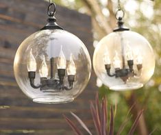 two clear glass globe lights hanging from a chain