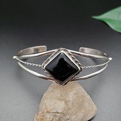 Elegant Adjustable Black Sterling Silver Bracelet, Classic Black Cuff Bracelet In Bangle Style, Black Polished Cuff Bracelet For Formal Occasions, Classic Black Cuff Bracelet Bangle, Formal Black Cuff Bracelet With Polished Finish, Formal Black Polished Cuff Bracelet, Black Sterling Silver Bangle Bracelet, Black Sterling Silver Bangle Bracelets, Modern Black Sterling Silver Bracelet