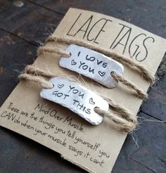 two metal tags with words on them attached to twine