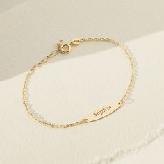 Celebrate your baby girls special day by gifting her with this beautiful thing engravable bracelet. A lightweight 5" bracelet crafted from 14k yellow gold that will fit safely and comfortably around your little girls small wrist. She will love to wear this toddlers engravable bracelet wherever she goes. Gift box included with. purchase. Dainty Customizable Nameplate Bracelets, Dainty Personalized Nameplate Bracelet, Dainty Nameplate Bracelet For Personalized Gift, Dainty 14k Gold Engraved Bracelet, Dainty Nameplate Bracelets For Personalized Gift, Dainty Engraved Name Bracelet For Personalized Gift, Dainty 14k Gold Bracelet With Custom Name, Dainty Personalized White Gold Bracelets, Dainty Personalized White Gold Name Bracelet