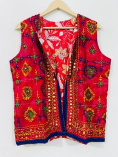 Fulkari open vest is made from a soft traditional indian phulkari handmade scarf. the scarves are used for festive occasions like weddings. the phulkari scarf is hand embroidered and embellished by indian artisan. vest has long wide vest coat. the vest jacket has an open front, and the length is normal jacket. indian chanderi silk phulkari hand work boho fashion kimono robe jacket. indian embroidered boho style beach wear body cover up. reversible vest jackets/coat you can wear this one in both side one side is phulkari embroidered and other side is cotton printed. *buy it for the holidays! looks fabulous over a long silk tank dress or palazzo pants. or wear it with to install jeans and boots. measurements: colour: as per the picture approx length : 23 inch / 60 cm bust approx : 40 inch / Cotton Nehru Jacket With Pallu For Festivals, Sleeveless Cotton Traditional Wear For Festivals, Bohemian Choli With Zari Work For Celebrations, Festive Bohemian Vest, Traditional Cotton Nehru Jacket For Festivals, Traditional Red Nehru Jacket, Multicolor Bohemian Vest For Festive Occasions, Multicolor Embroidered Nehru Jacket For Diwali, Transitional Season Multicolor Nehru Jacket For Festive Occasions